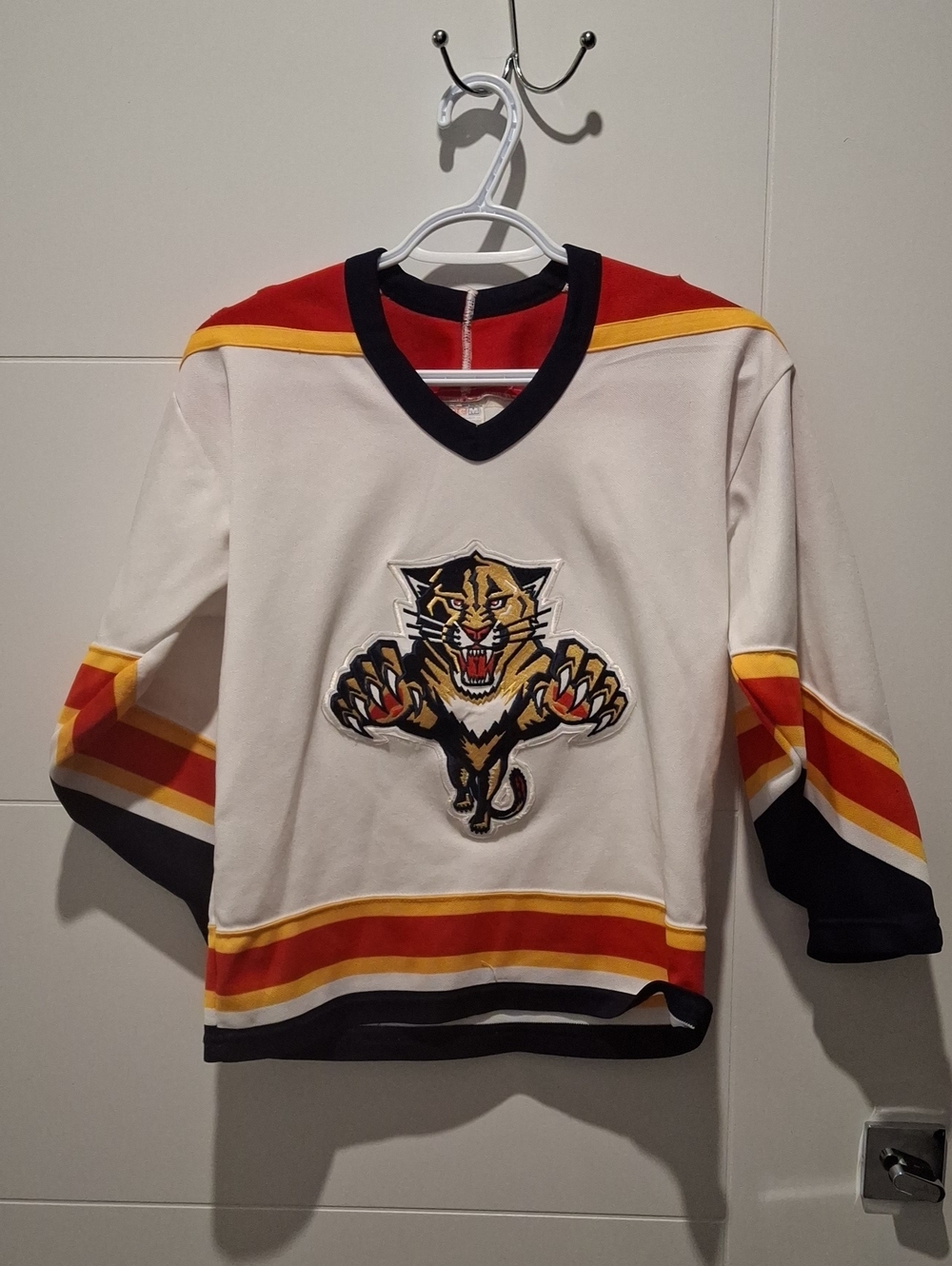 CCM White Kids Hockey Jersey with Panther Crest and Red-Yellow Stripes